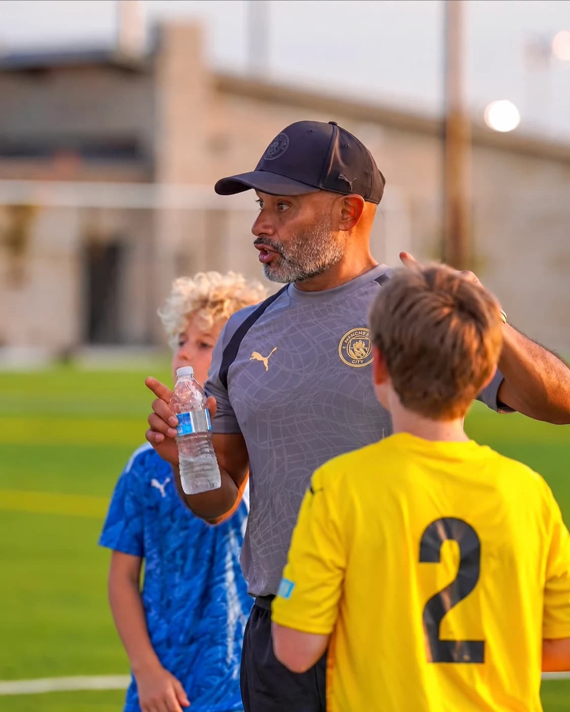 Alberto Carbajal guiding young players in Manchester City training kit