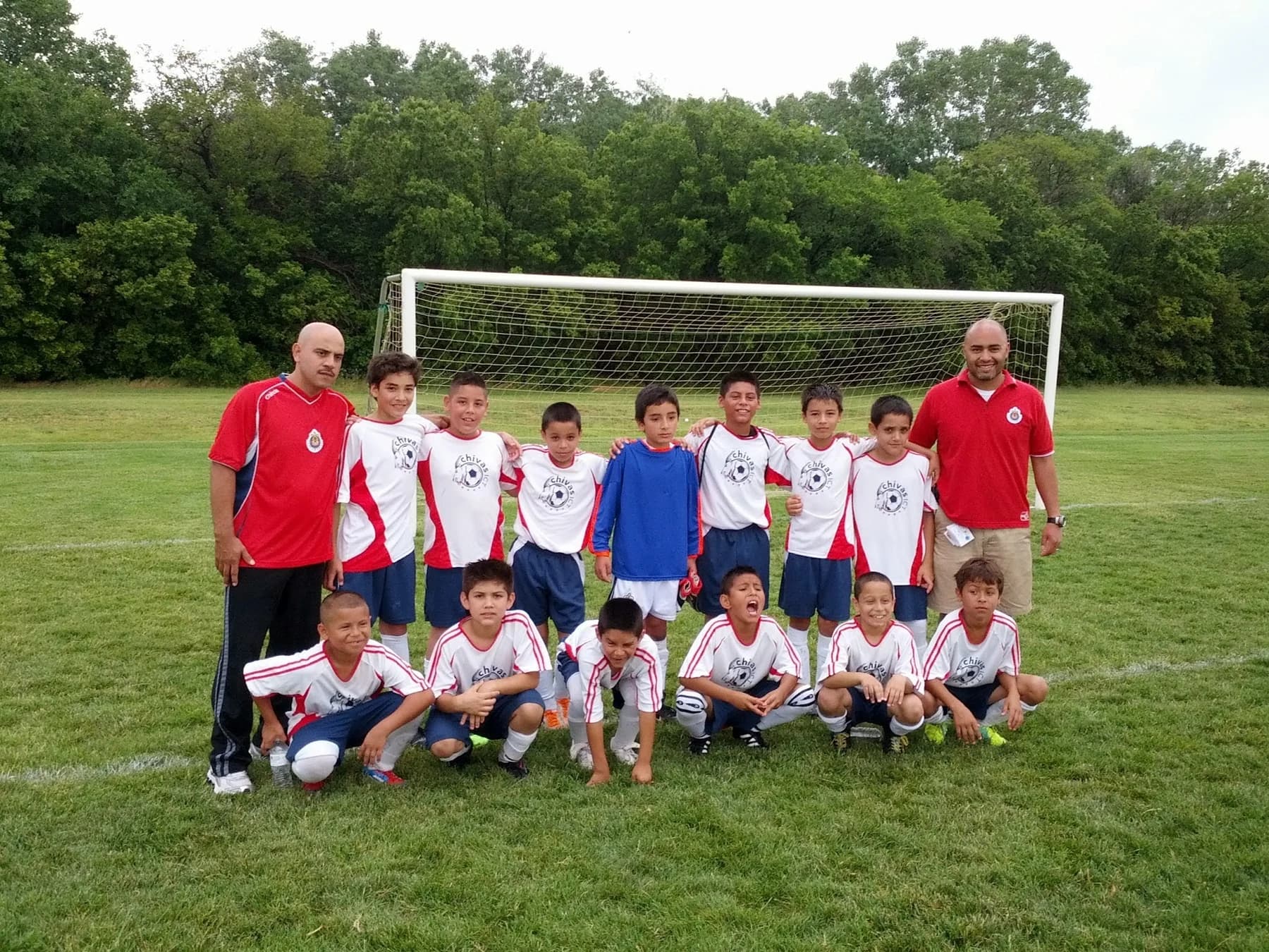Alberto Carbajal with his CHIVAS ICT youth football team on the pitch