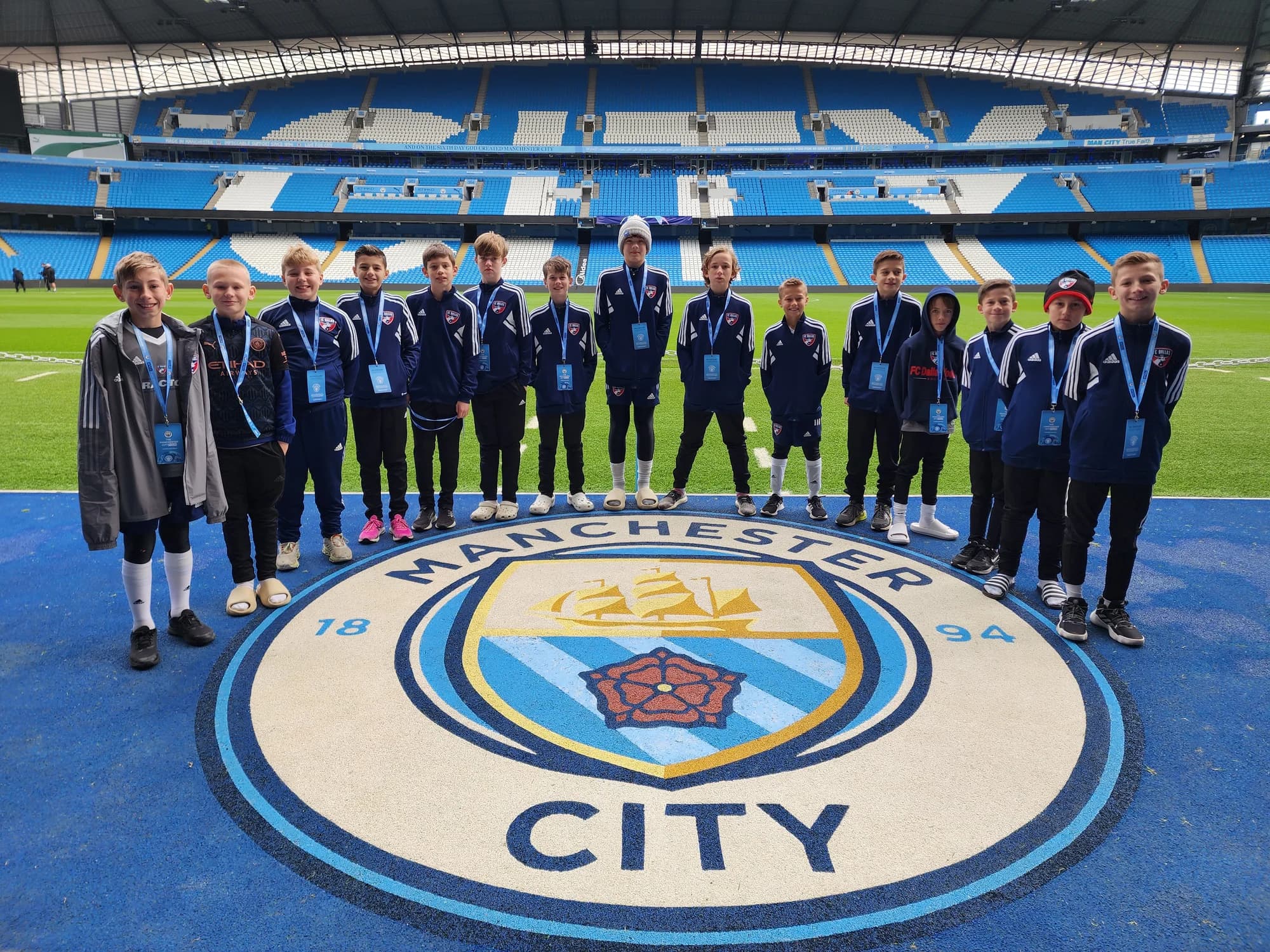 Players and coaches gathered beside the Manchester City crest inside the stadium during the England 2023 trip